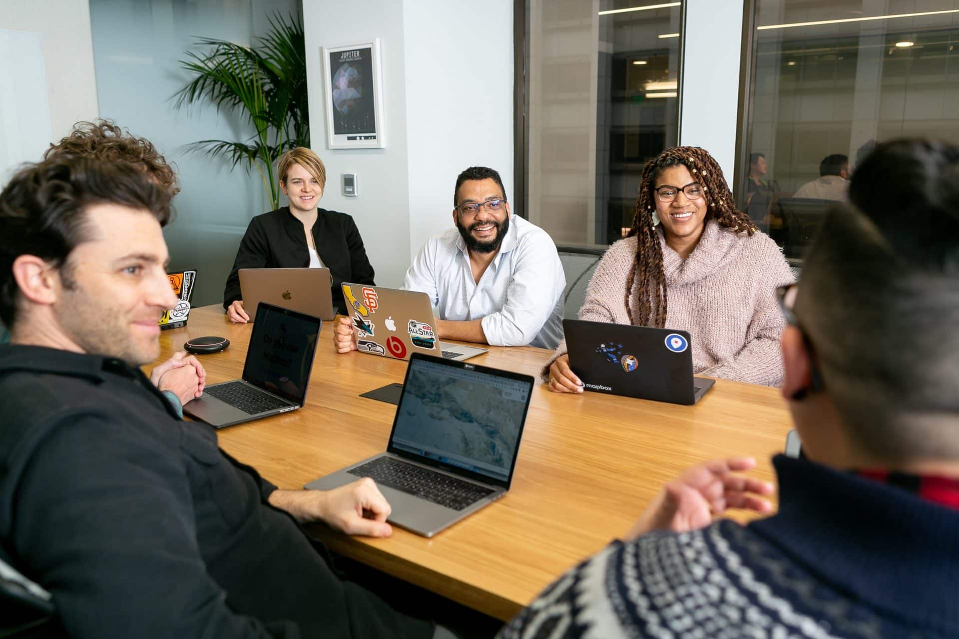 diverse group of business people sit around a table