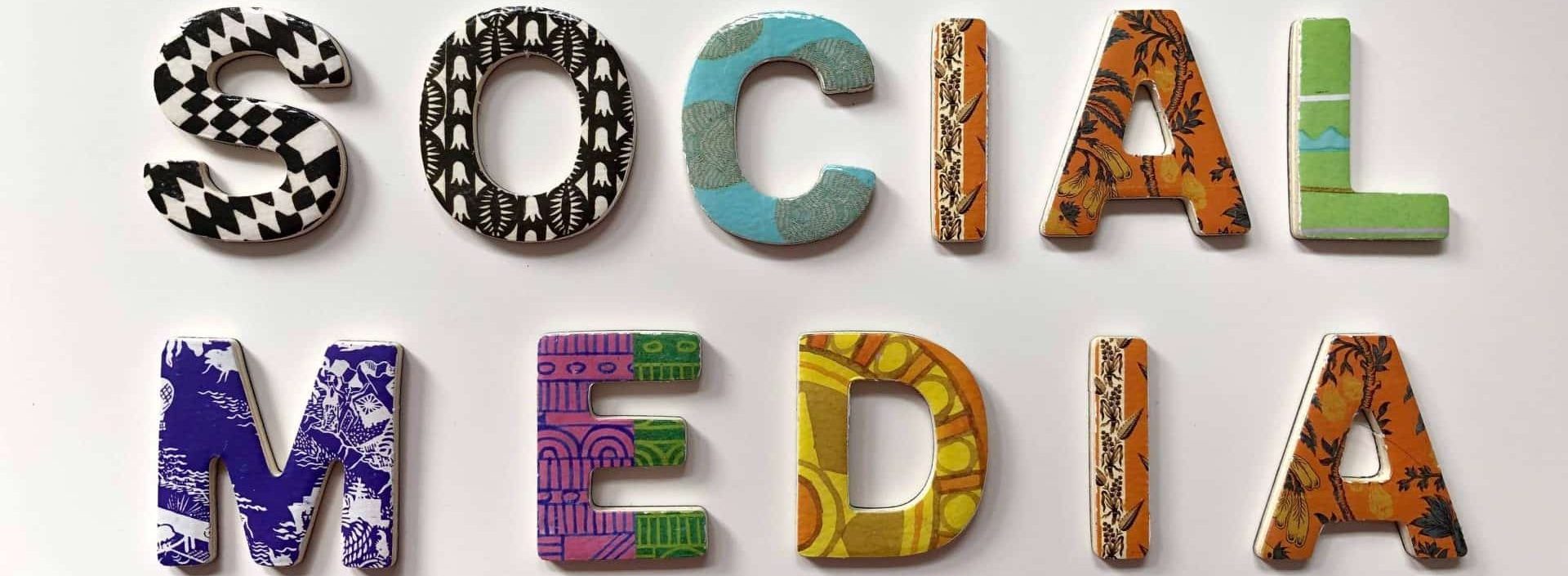 The word "social media" spelled out with each letter having a unique design that represents social media management services.