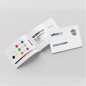 Open style guide booklet for a Philadelphia community center showing colorful skin tone brand colors, typography, and campaign logo on display.