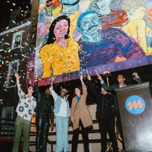 Nile Livingston joined by other artists to celebrate a mural piece, "Finally on 13th", that honors figures from the Philadelphia Ballroom, their credits in sharing the scene. 