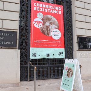 striking_bold_banner_design_sidewalk_sign_Chronicling_Resistance_exhibition_front_tent_library