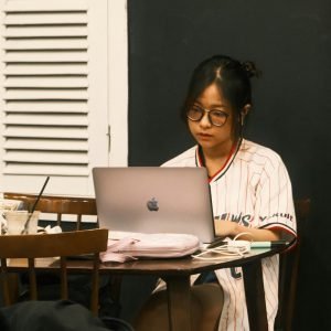 Woman working remotely at cafe on laptop