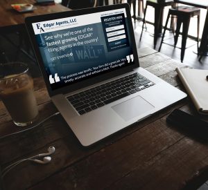 An open laptop on a wood table displaying the new Edgar Agents, LLC landing page designed by Creative Repute
